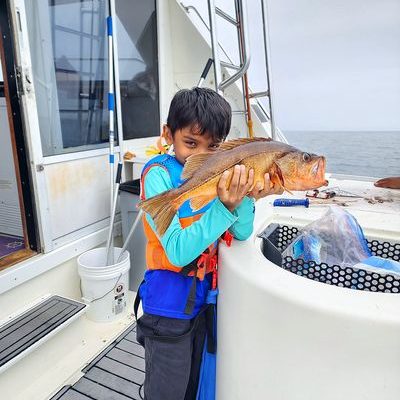 Captain and guest show off a bright vermilion rockfish. Captain and guest show off a bright vermilion rockfish.
